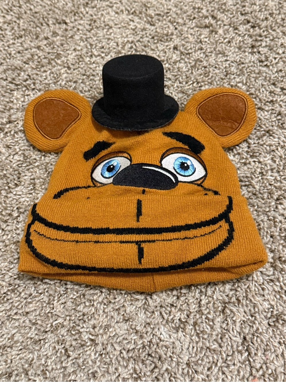 Source Unknown Tan Bear Knit Beanie with Black Top Hat and Blue Eyes